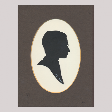 
        Front of silhouette, with man in frame looking right, wearing glasses.